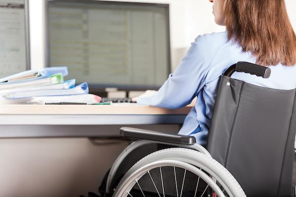 Student in wheelchair working at computer.